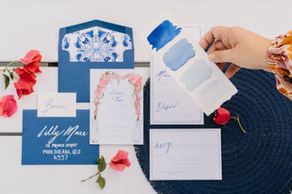Santorini Destination wedding inspiration of blue and white invitation with pops of pink