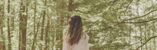 Girl with long flowing hair looking out over trees