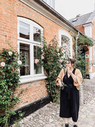 australian artist rebecca eddison travelling through denmark with her camera. Walking down a cobbled street, eating an icecream
