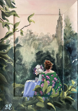 A framed painting depicting a woman seated at a table in a lush garden, seen from behind. She is sitting at a garden table with flowers in a vase and a mug of tea. The scene includes a pale pink sky, a tall pine in the background, and green foliage framing the composition.